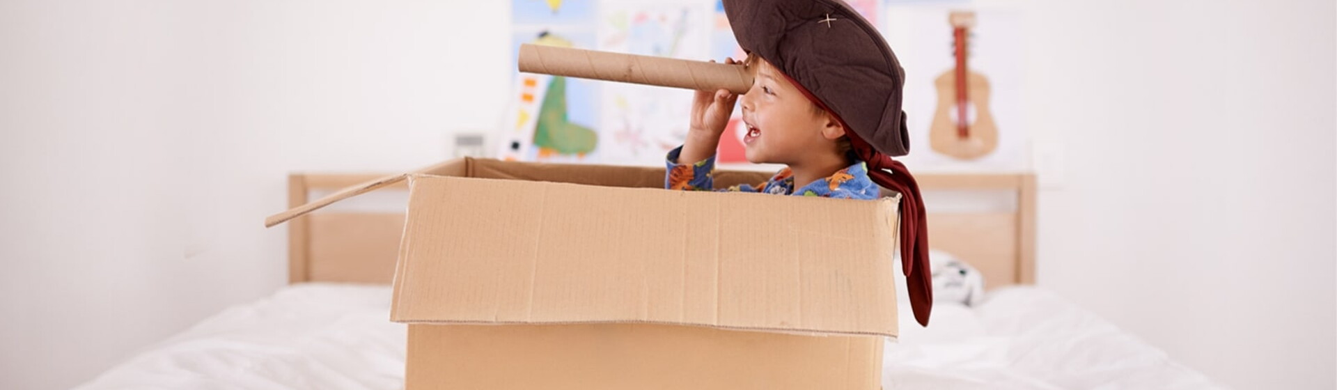 boy with pirate costume in a box