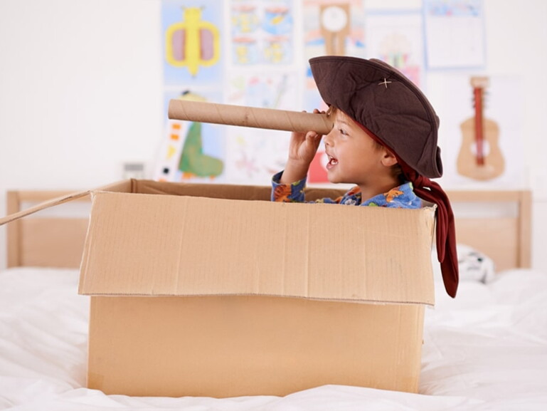 boy with pirate costume in a box